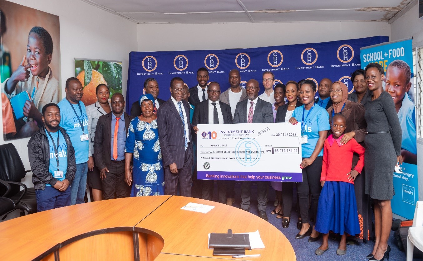 CDHIB team pose with Mary’s Meals team, representatives from the Ministry of Education and with some of the beneficiary learners from Mbinda Primary School