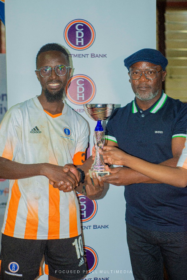 In the picture: Evance Mwaisunga (L) CDH Investment Bank football team captain captured receiving a champions trophy from Thoko Mkavea, CDH Investment Bank Deputy Chief Executive Officer and Executive Director at the prize presentation ceremony held at the Country Club in Limbe on 22nd October 2022