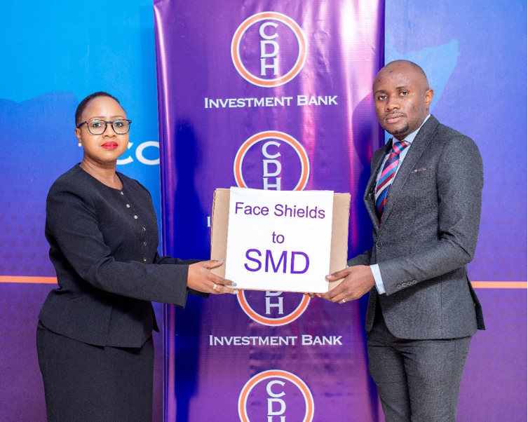 Mrs Beatrix Mosiwa-Ndovi, Chief Finance Officer of CDH Investment Bank hands over a box containing face shields to Dr Yamikani Moyo 