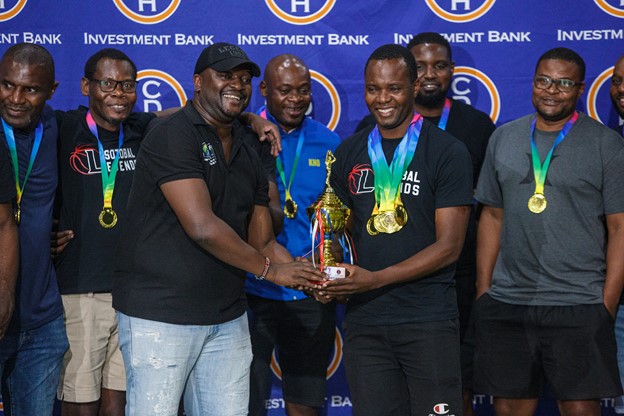 Sozobal Legends (veterans) Captain, Mr Hope Chisamanga receiving their trophy from Basketball Association of Malawi (BASMAL) Vice Chairperson, Mr Banthali Banda