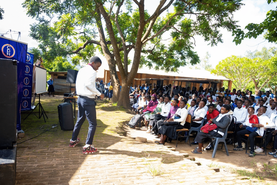 A student addressing fellow learners during the 2025 Global Money Week commemoration at PIM Community Day Secondary School 
